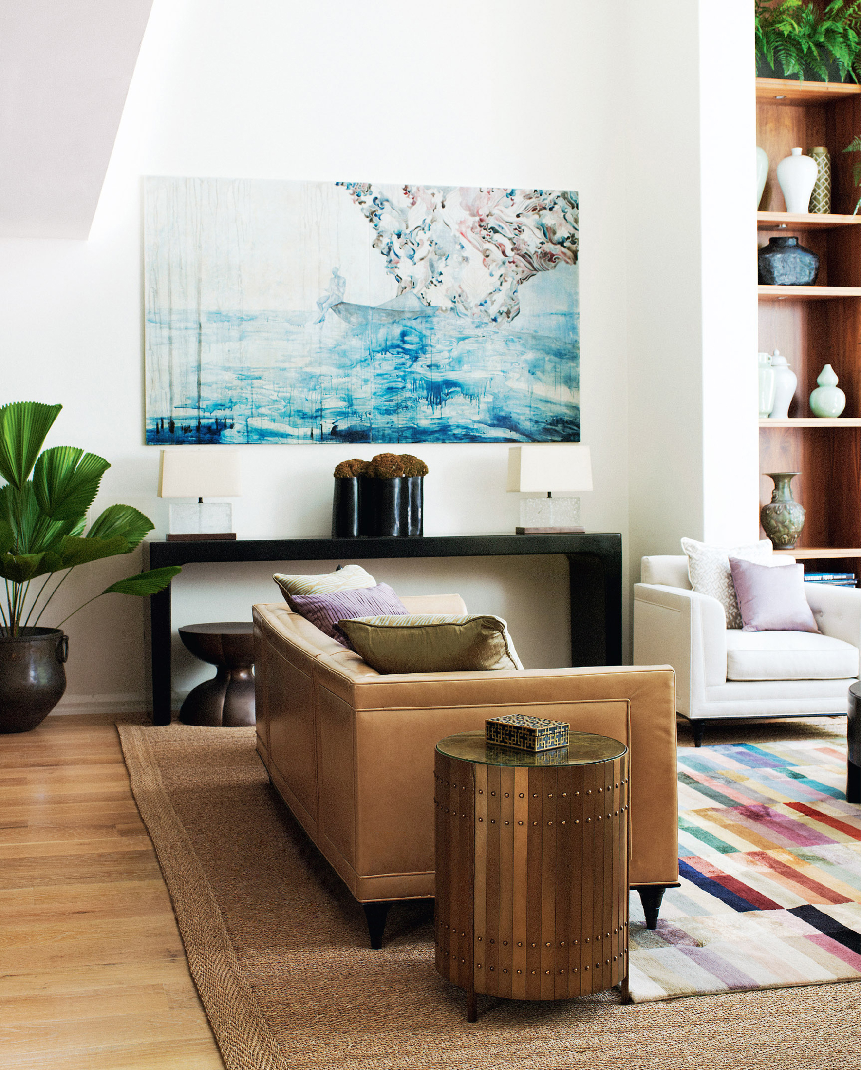 Formal sitting area with artwork by Belinda Fox, console and leather sofa, by Sydney interior designers, Brendan Wong Design