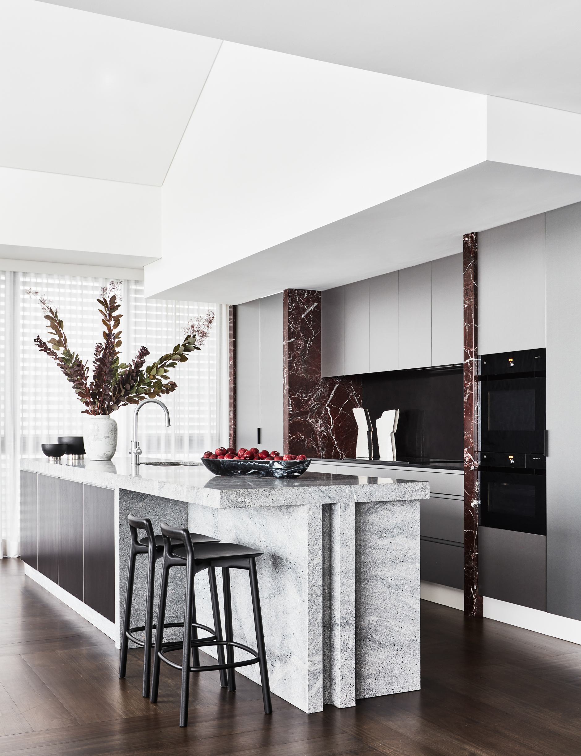 Modern kitchen renovation with stone island and timber parquetry floor by Sydney interior designers, Brendan Wong Design