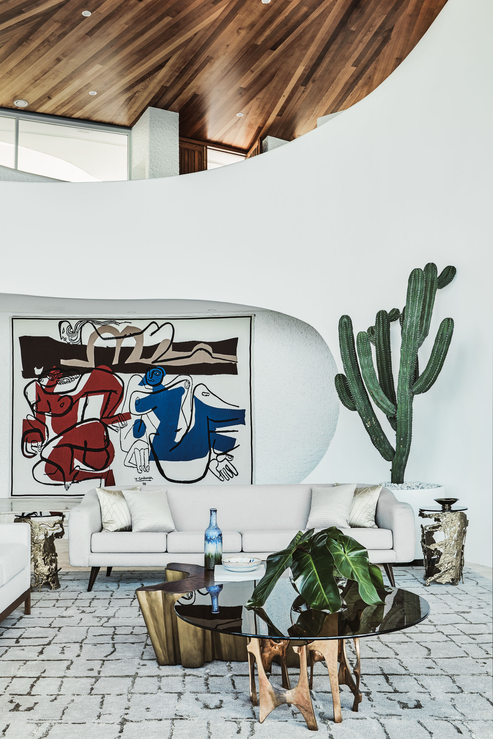 White living room with Le Corbusier wall tapestry and mid-century furniture by Sydney interior designers, Brendan Wong Design
