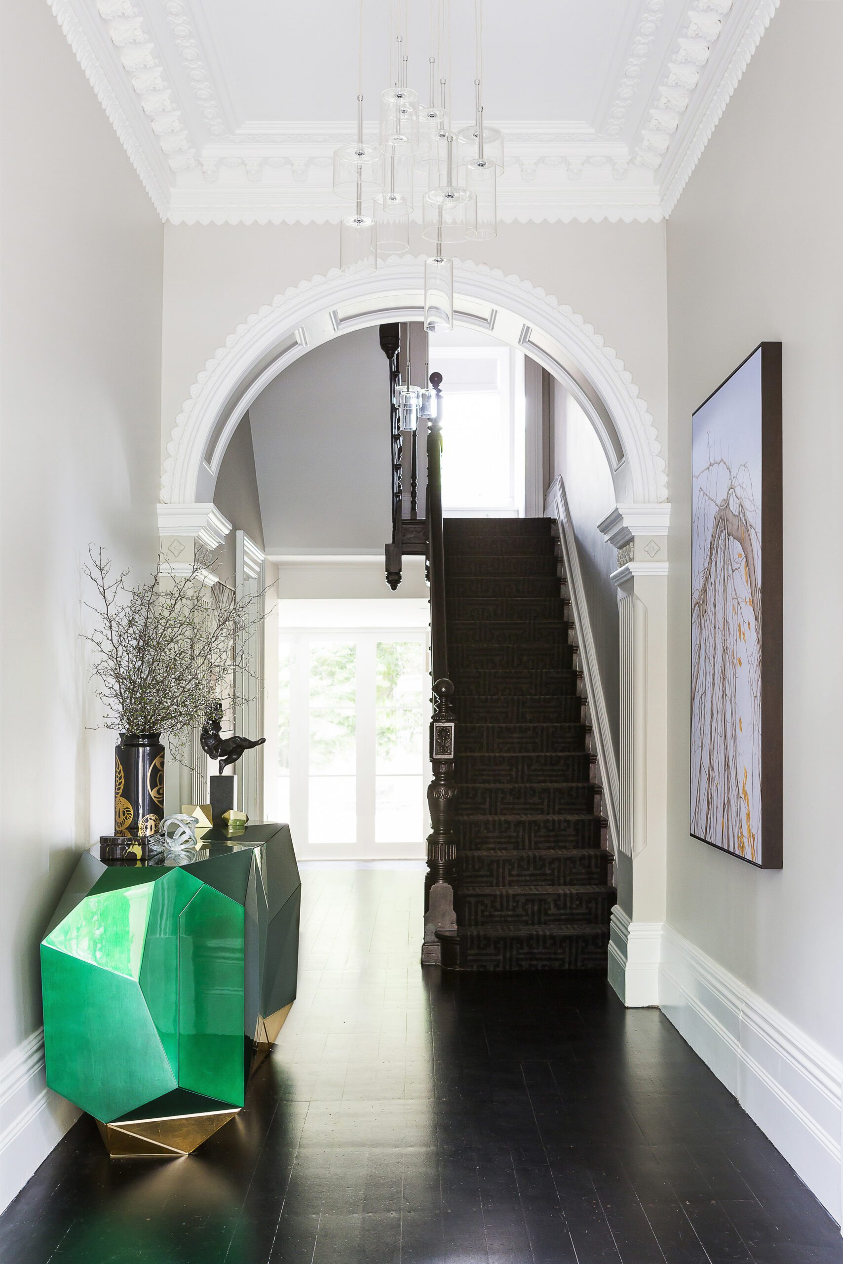 Hallway with green faceted sculptural sideboard and black timber floor, by Sydney Interior designers Brendan Wong Design