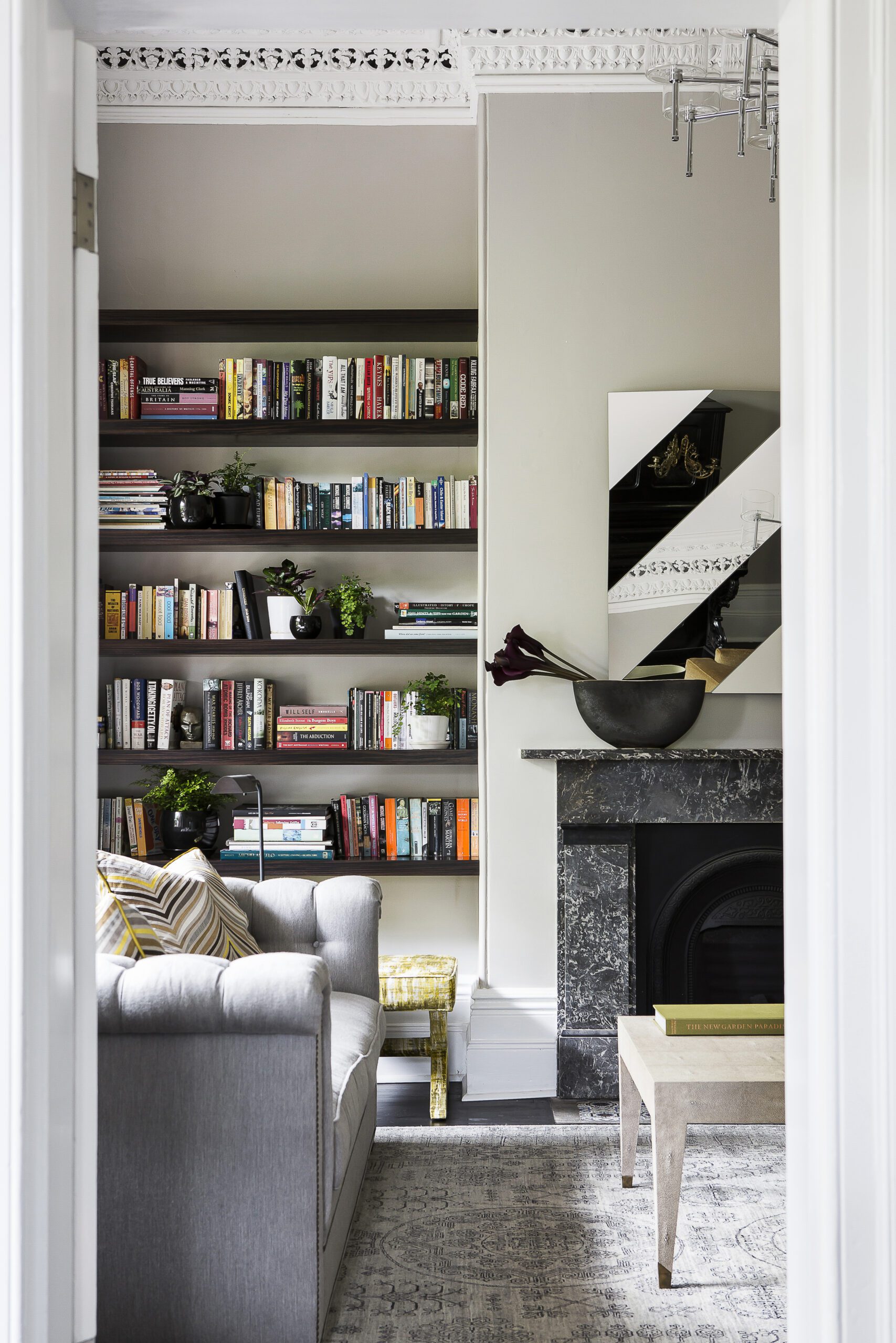 Victorian house living room with black marble fireplace and grey sofa, by Sydney interior designers, Brendan Wong Design