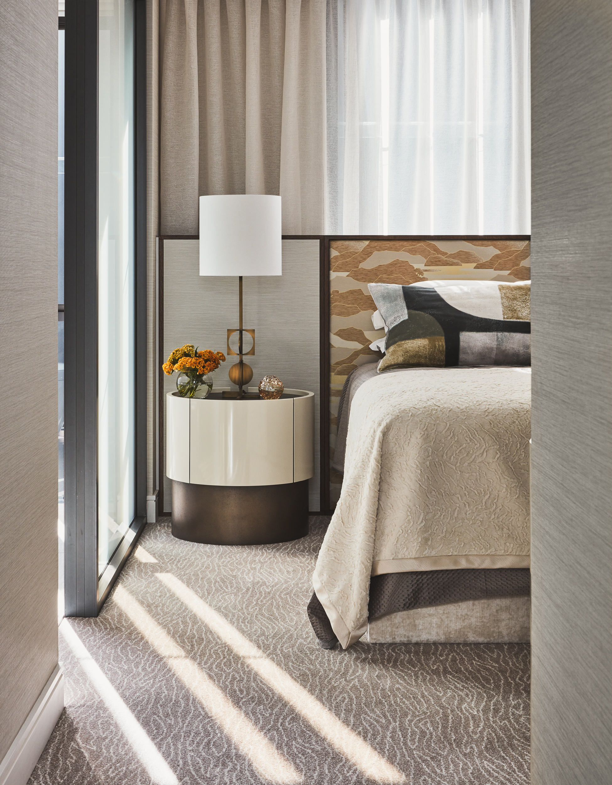 Master bedroom design with custom bed in Lelievre fabric and bronze bedside by Sydney interior designers, Brendan Wong Design
