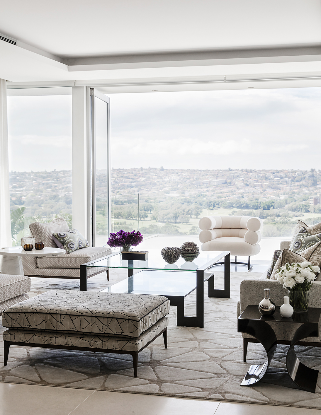 Premium lounge room with sweeping district views by Sydney Interior Designer, Brendan Wong