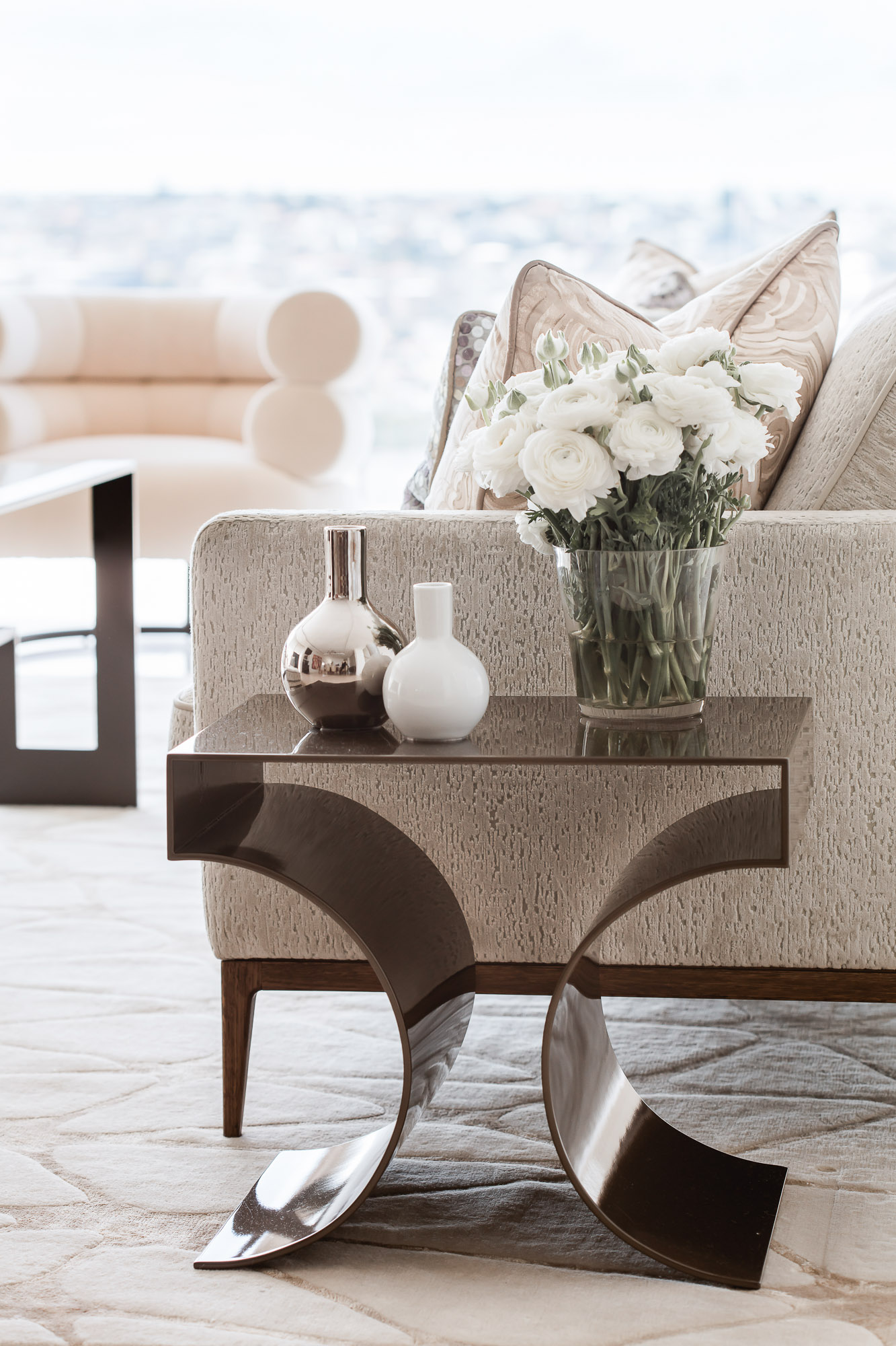 Side table decoration with floral vase on bronze metal side table, by Sydney interior designers, Brendan Wong Design