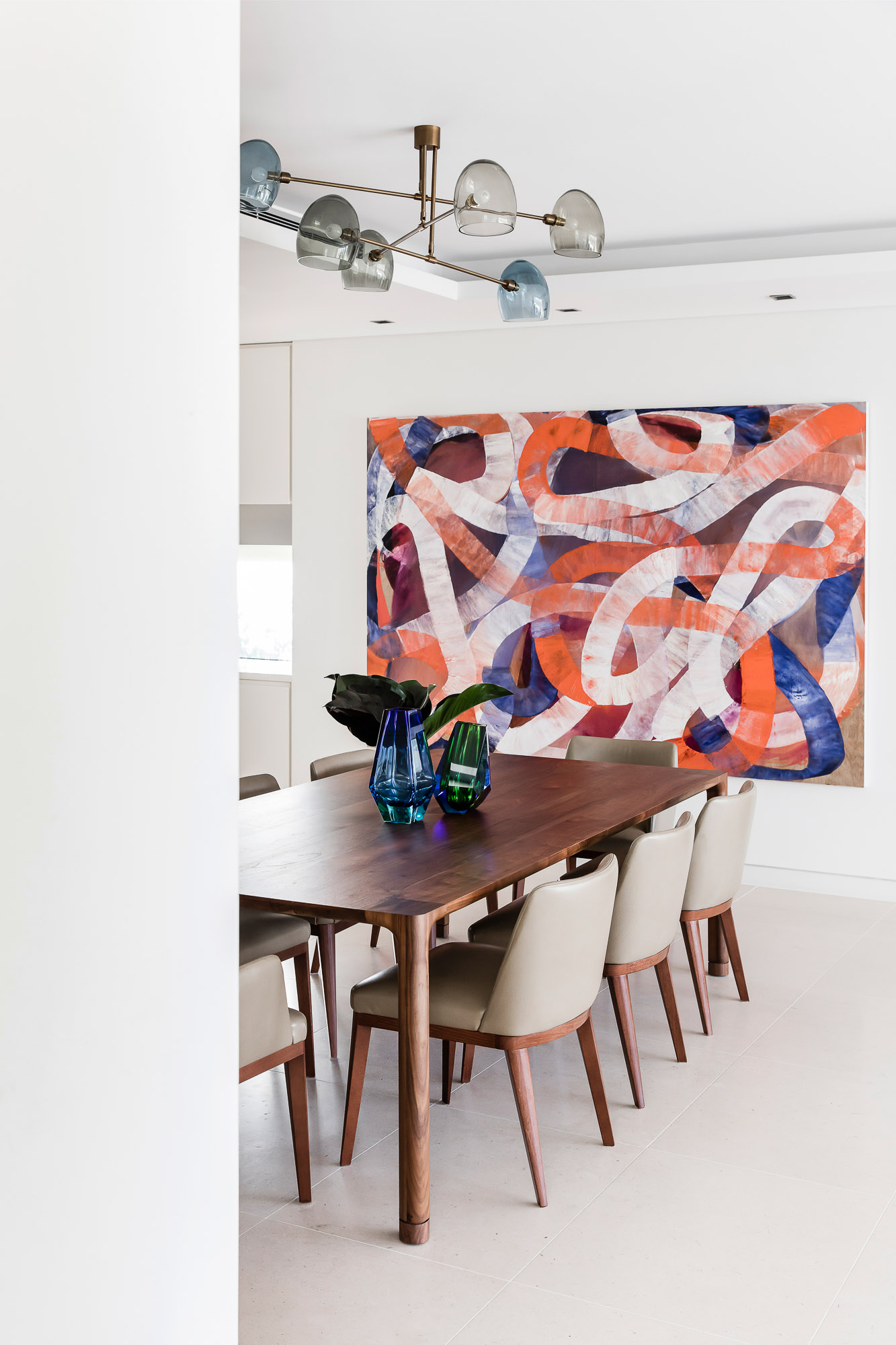 Bright dining room space with timber table and contemporary painting artwork by Ildiko Kovacs, by Sydney interior designers