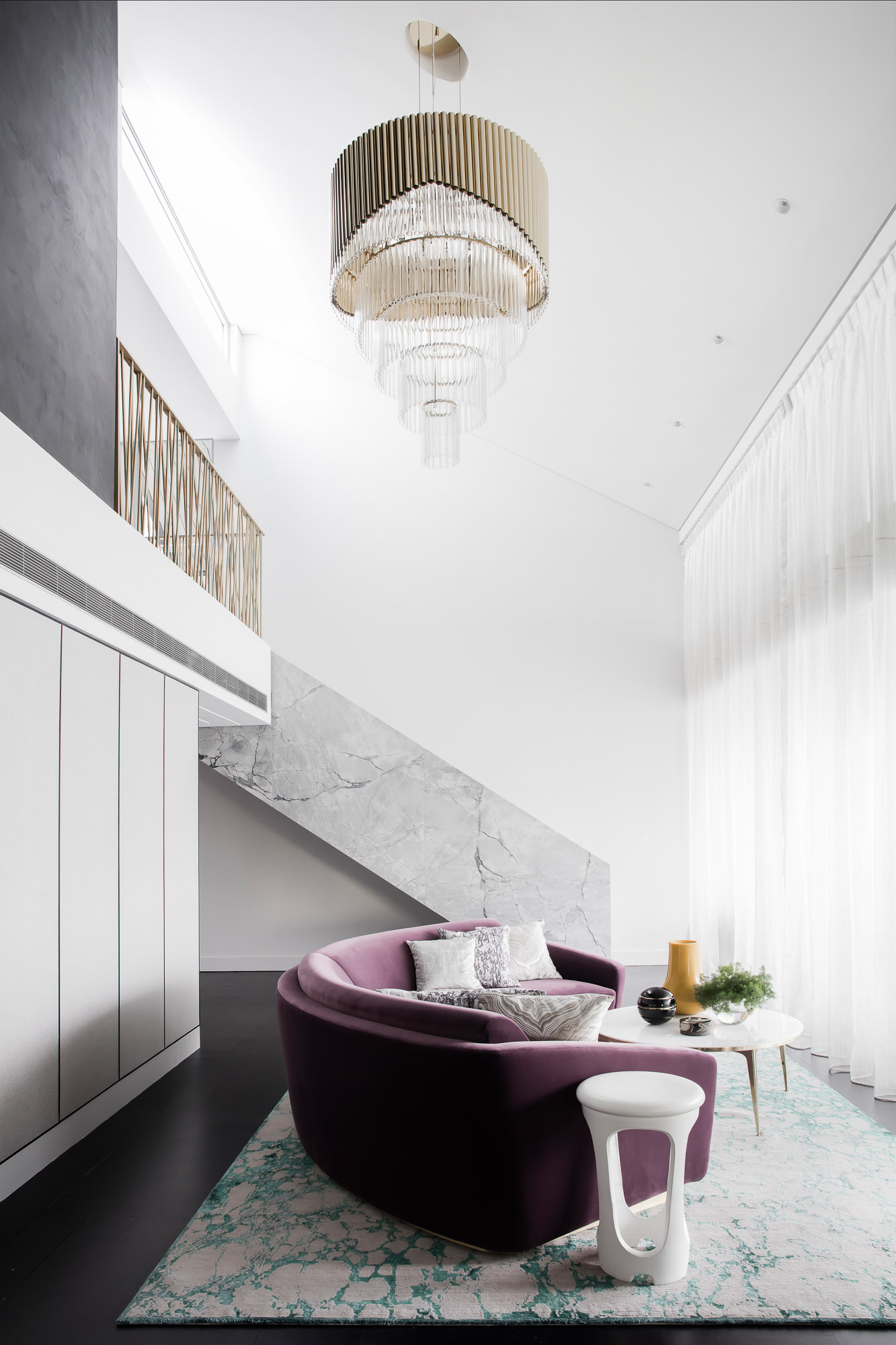Pyrmont penthouse renovation with marble stairs, brass chandelier, and purple curved sofa by Sydney interior designers