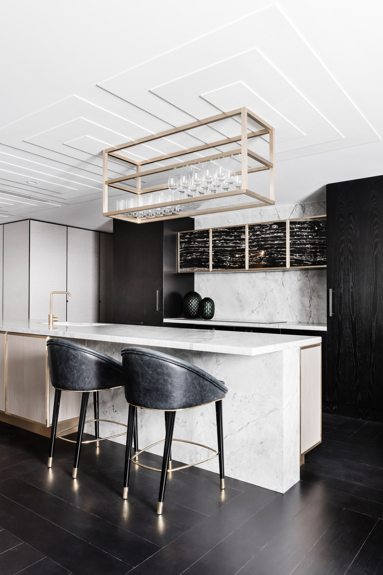 black marble kitchen renovation with brass finishes, black oak cupboards and white marble island by Sydney interior designers