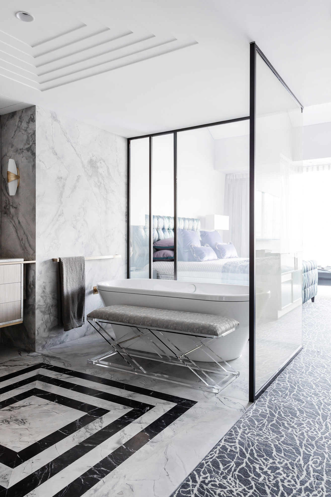 Black and white marble bathroom renovation with switchable glass by Sydney interior designers Brendan Wong Design