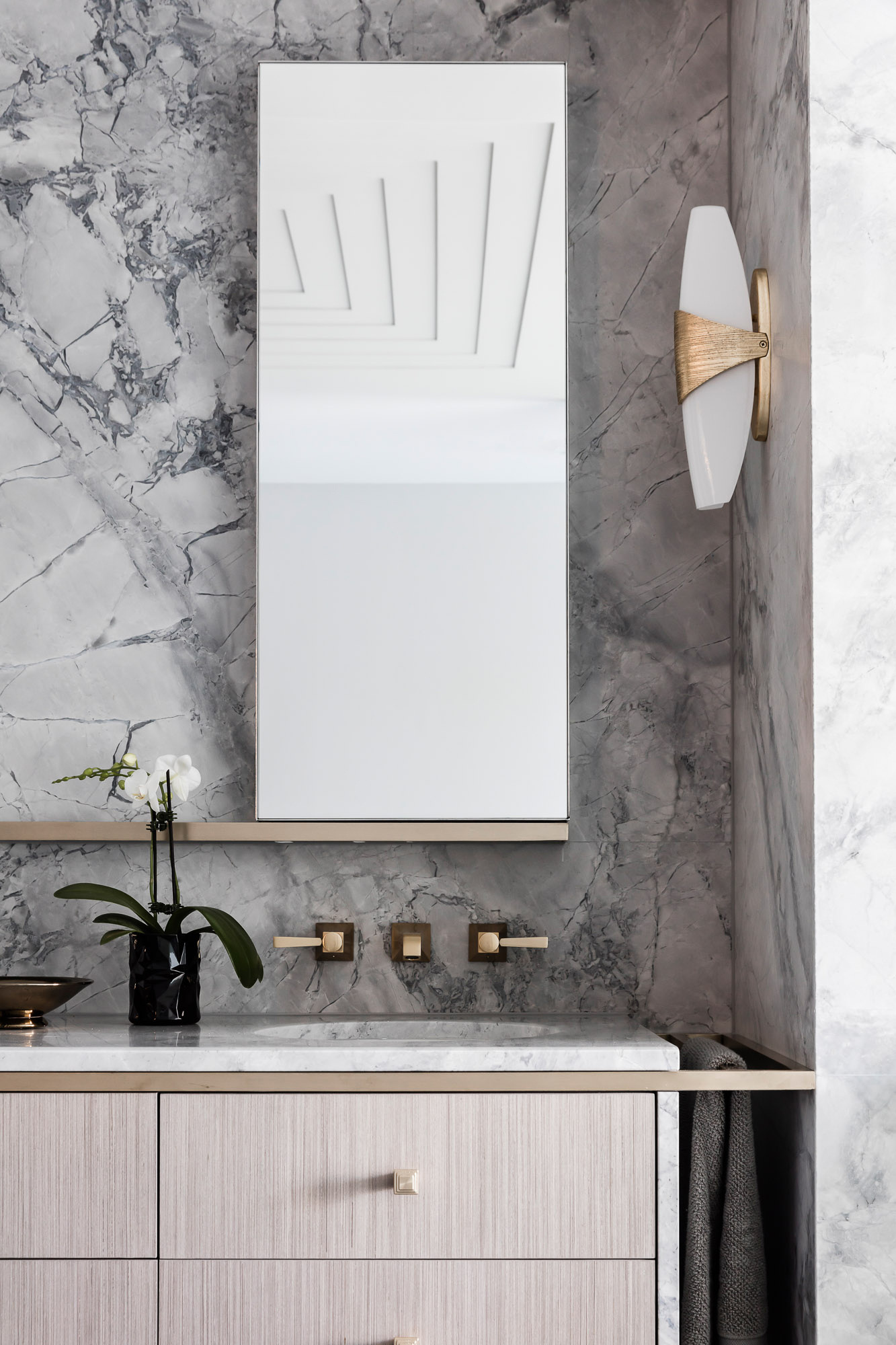 Black and super white marble bathroom renovation with brass taps by Sydney interior designers, Brendan Wong Design