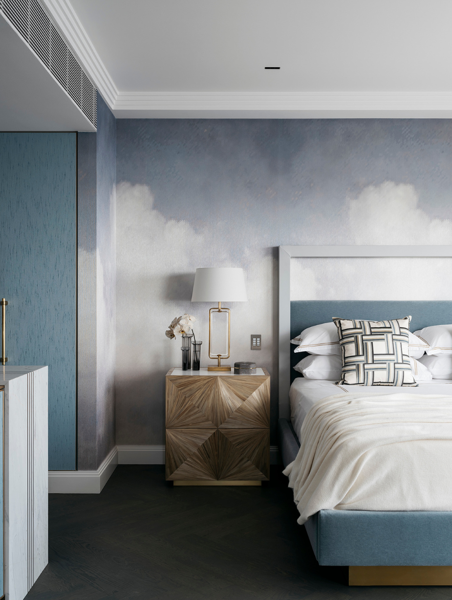 Serene bedroom interior with cloud-inspired wallpaper, sculptural bedside table, and layered soft furnishings, styled by Brendan Wong Design for a Point Piper apartment.