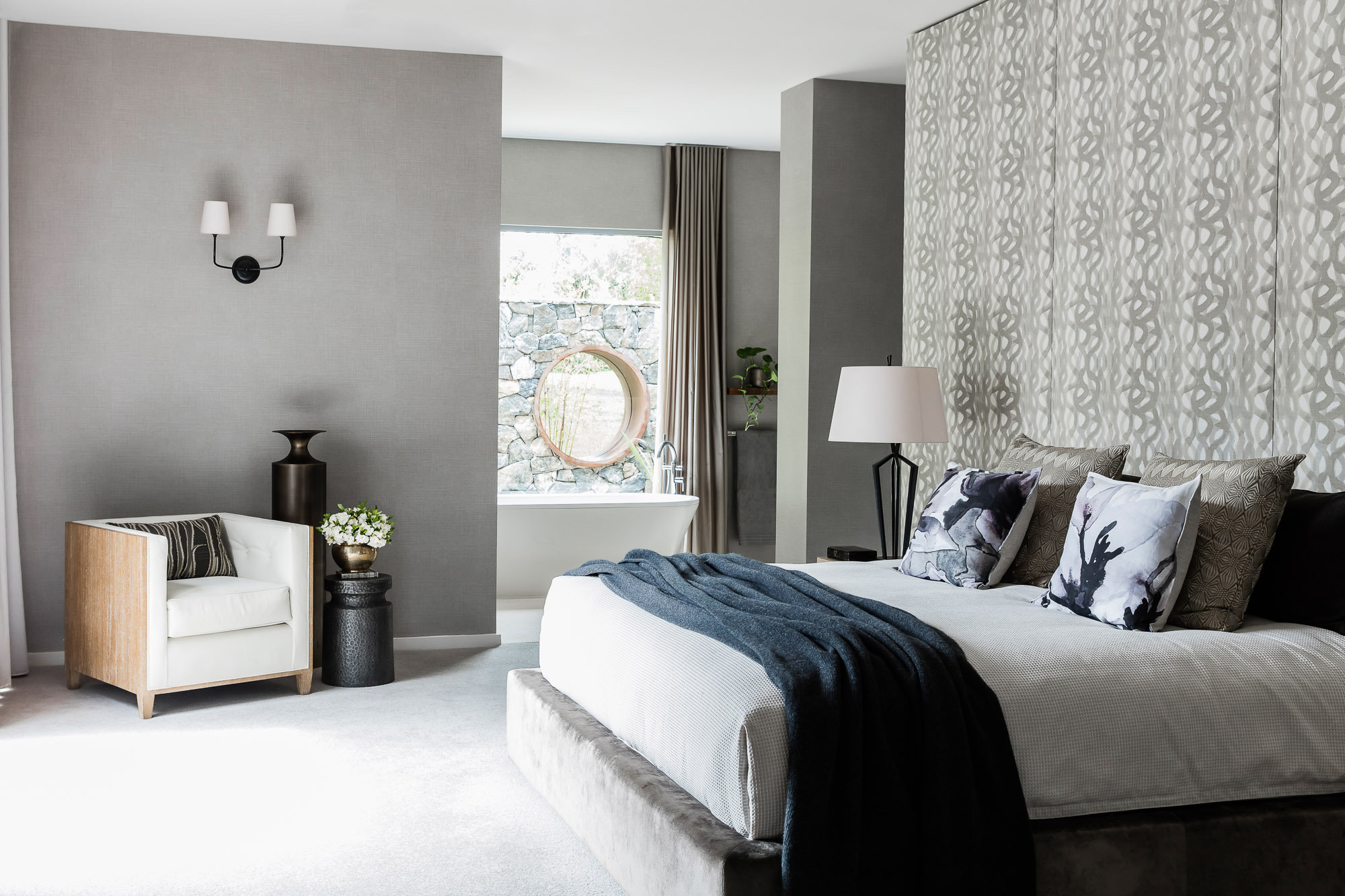 Textured bedroom retreat with feature grey and blue accents, oversized windows, and bespoke soft furnishings, designed by Brendan Wong Design for a luxury Hills home.